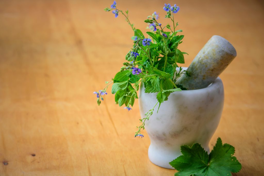 pexels photo 105028 105028 Marble mortar and pestle with fresh herbs and flowers on wooden table enhancing natural health and cooking aesthetics.