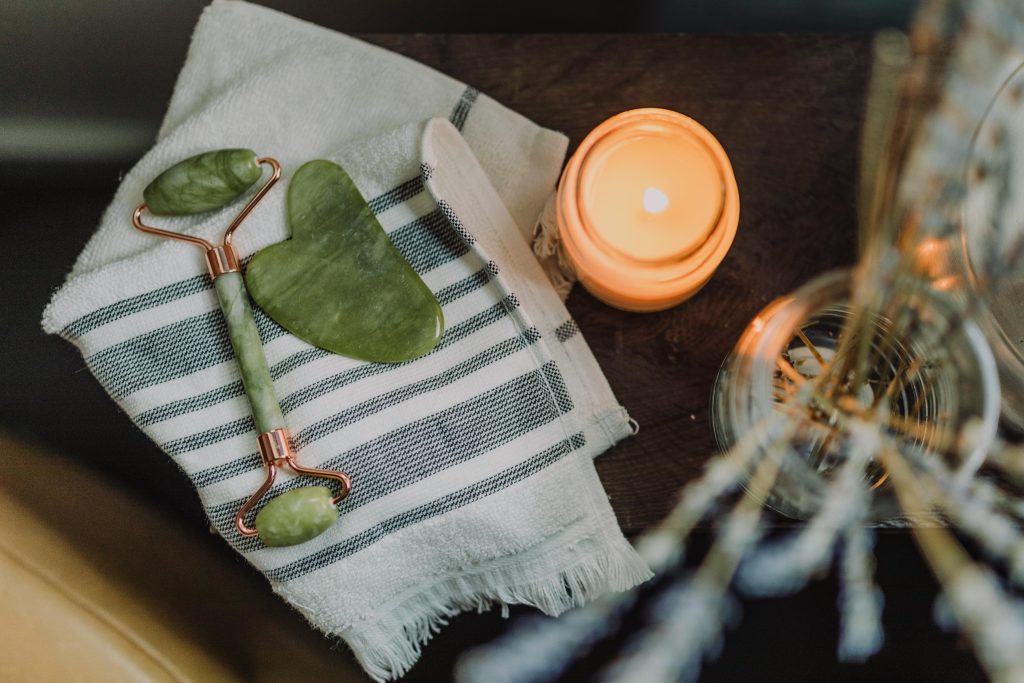 pexels photo 6724448 6724448 A serene spa setup featuring a jade roller, gua sha, towel, and candle for ultimate relaxation.